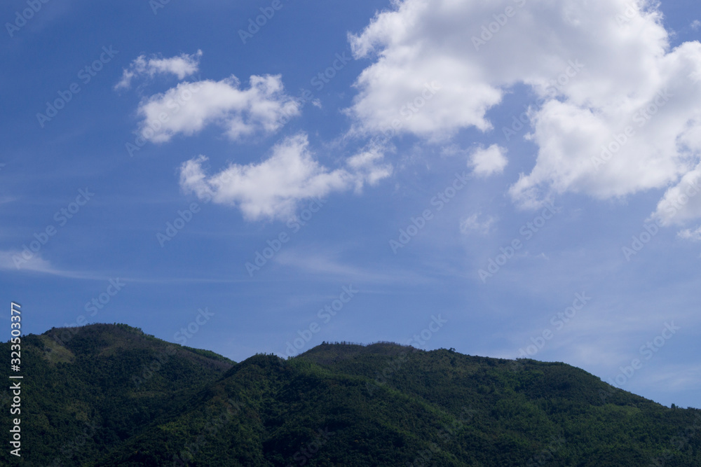 mountains against the blue sky and clouds mountains against the blue sky and clouds