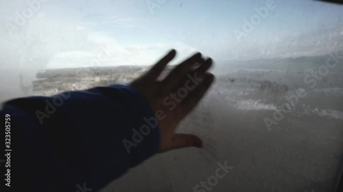 hand wipes the wet glass in the car
