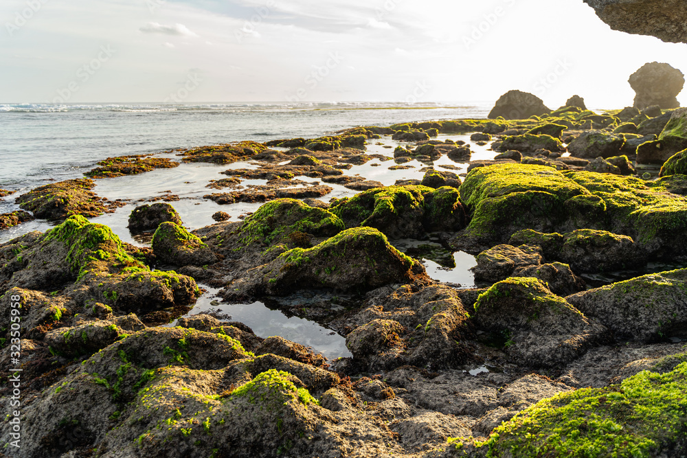 Ocean washing stones on coast stock photo