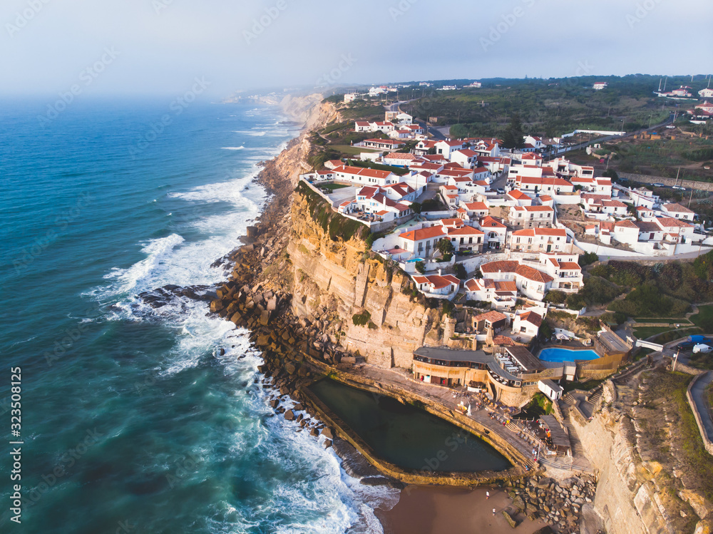 Aerial view of Azenhas Do Mar, municipality of Sintra, a seaside village on the Portuguese coast northwest of Lisbon, Portugal, shot from drone, with Atlantic Ocean view