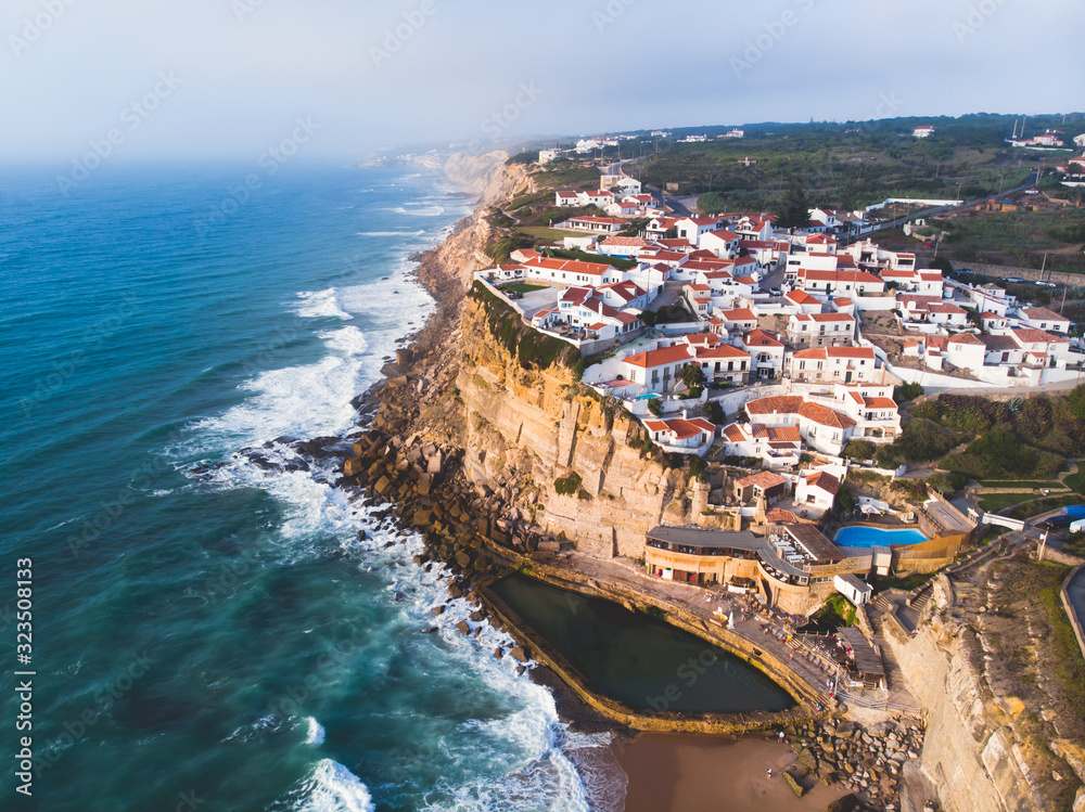 Aerial view of Azenhas Do Mar, municipality of Sintra, a seaside village on the Portuguese coast northwest of Lisbon, Portugal, shot from drone, with Atlantic Ocean view