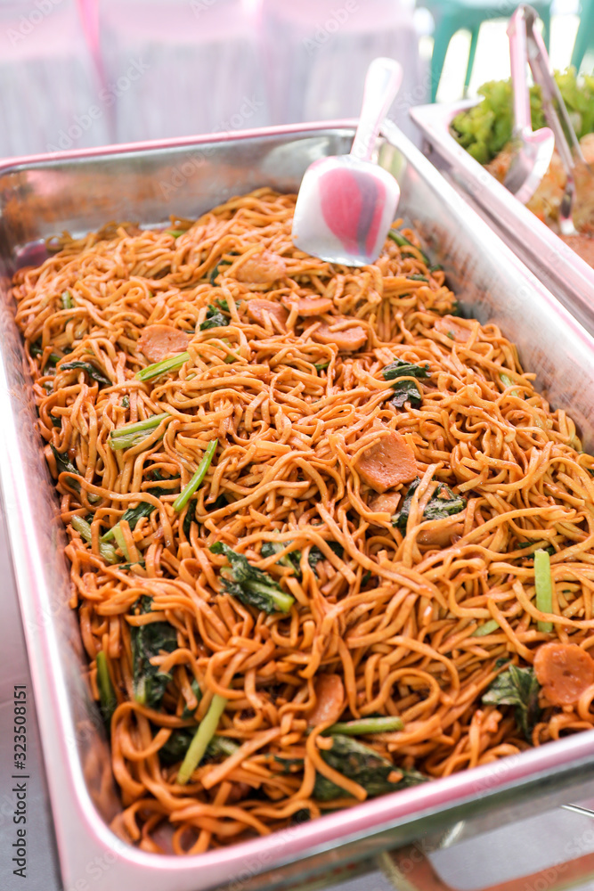 Fried noodles with fried egg, vegetable and coriander