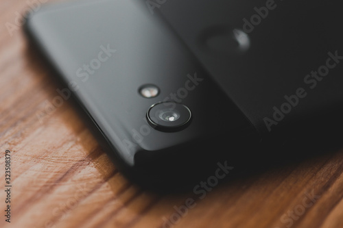 top view of google pixel smartphone lens on wooden background