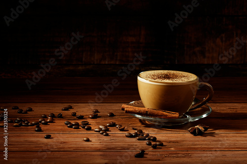 Cup of coffe Cappuccino with milk on a dark background. Hot coffe ,latte or Cappuccino prepared with milk on a wooden table with copy space