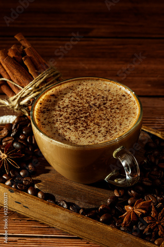 Cup of coffe Cappuccino  with milk on a dark background. Hot coffe ,latte or Cappuccino prepared with milk on a wooden table with copy space