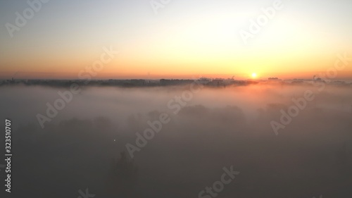 Morning fog over the river in the city.