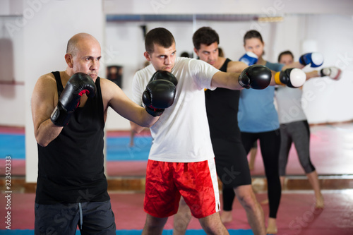 Happy people practicing boxing punches © JackF