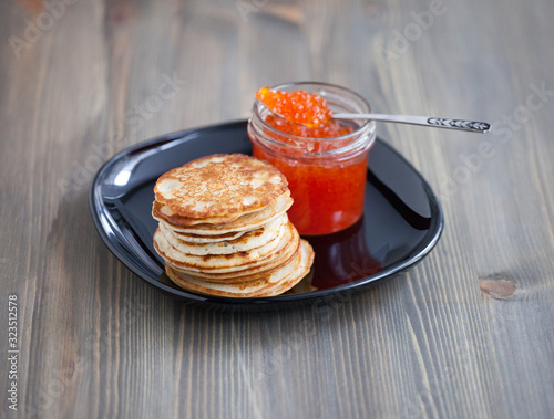 Stack of thin Russian pancakes with caviar for Shrovetide Butter week festival meal, pancakes day meal, Shrove Tuesday ( Mardi gras and Fat Tuesday) photo