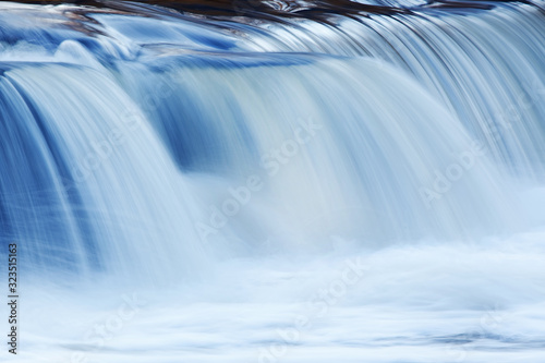 Landscape captured with blurred motion of a cascade on the Rabbit River  Michigan  USA