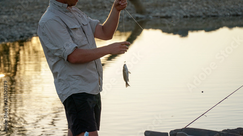 Caucasian male fishing during sunset at Purnululu National Park in East Kimberley, Western Australia. photo