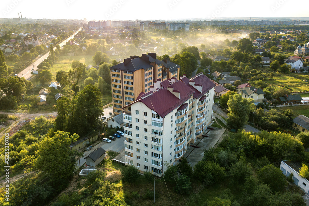 Aerial view of multistory apartment buildings in green residential area.