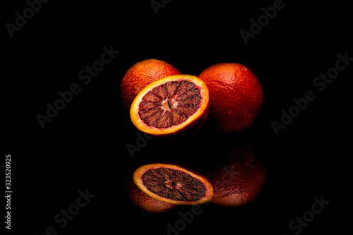 Orange combined with pomegranate on a black background.