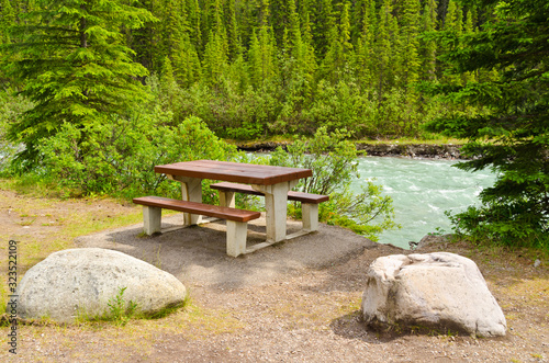 A picnic table with gorgeous view at mountain river, British Columbia, Canada.