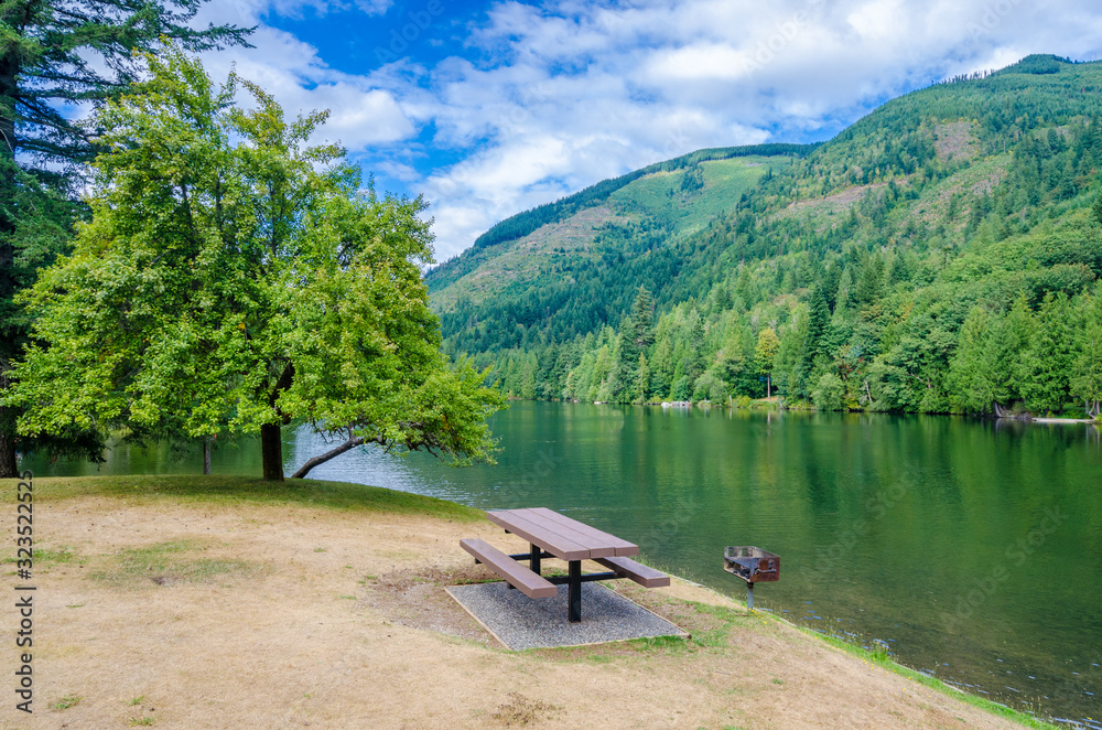 Fototapeta premium Picnic tables near mountain lake in Vancouver, Canada.