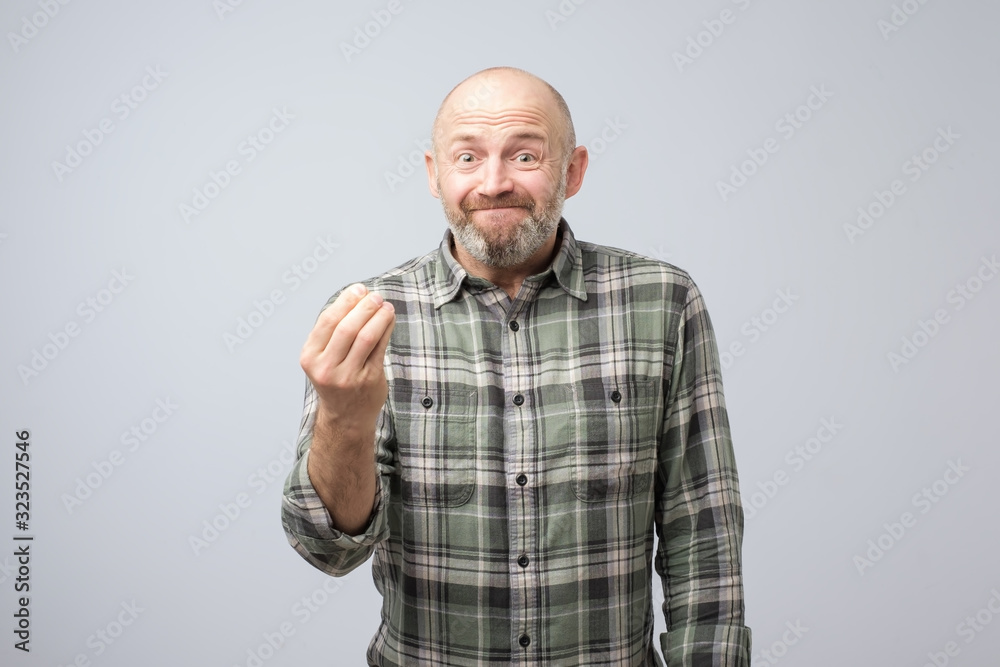 Senior handsome man showing italian gesture that means what do you want over white background. Quarrel with wife or coworker
