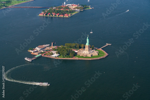 An Aerial photograph of the Statue of Liberty and Liberty Island. Ellis Island is in the background photo