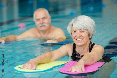 Vászonkép portrait of senior man and woman in swimming pool
