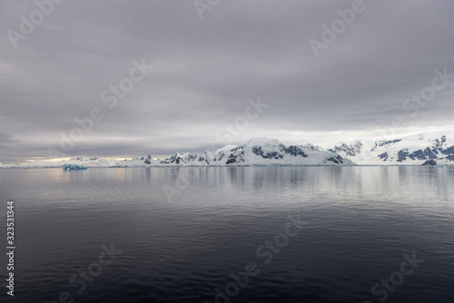 Antarctic beach with glacier and mountains  view from expedition ship