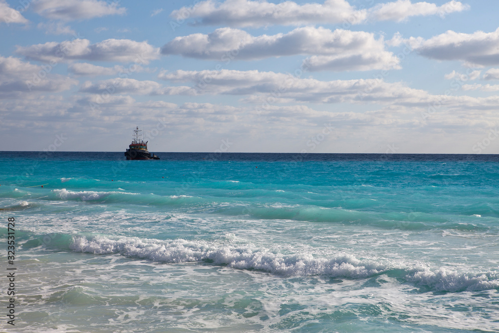 work ship in bright blue sea and sky with clouds.. work ship in bright blue sea and sky with clouds..