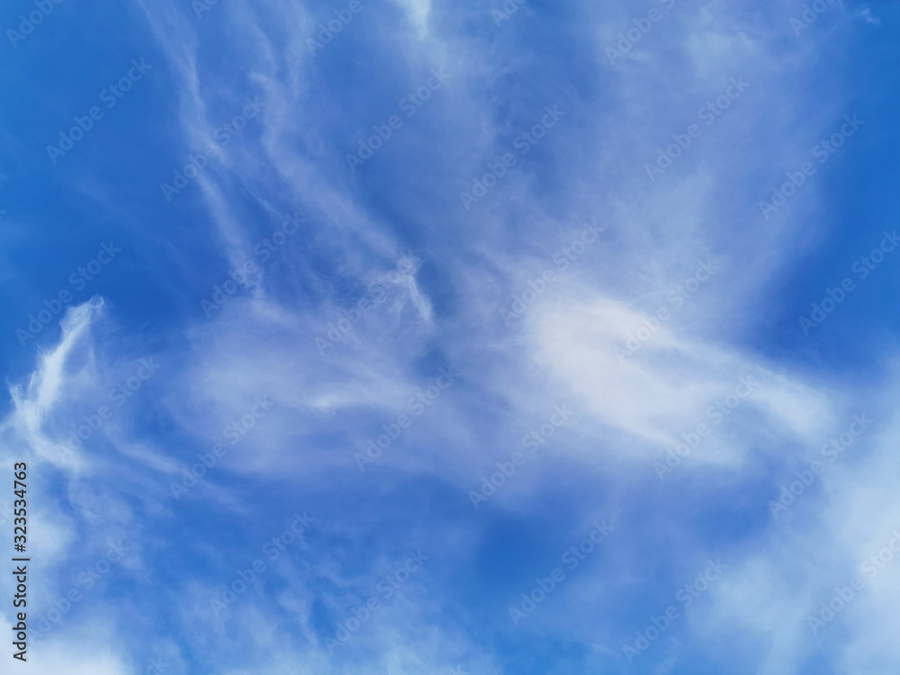 Bright blue sky with clouds, background for design, decoration or wallpaper Bright blue sky with clouds, background for design, decoration or wallpaper