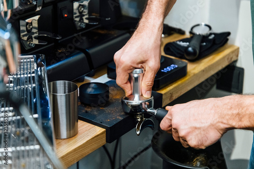Barista pressing coffee to portafilter