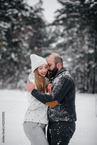 Couple playing with snow in the forest