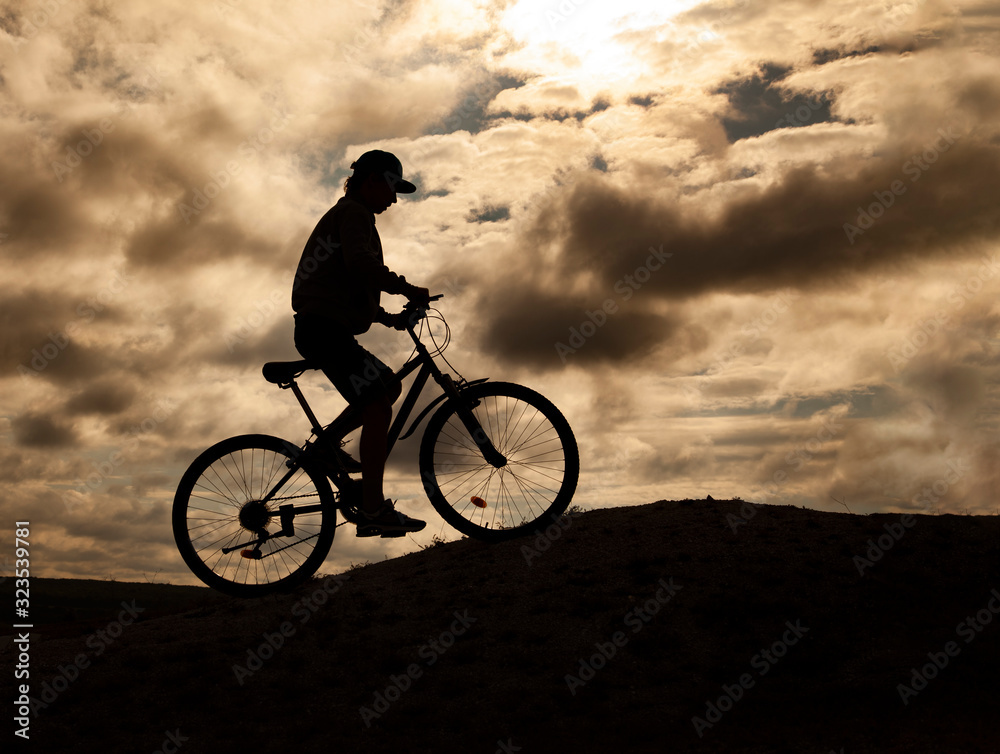 Silhouette of Mountain bike.Sport and healthy life.Extreme sports.Mountain bicycle and man.Life style outdoor extreme sport Silhouette of Mountain bike.Sport and healthy life.Extreme sports.Mountain bicycle and man.Life style outdoor extreme sport