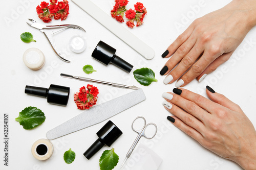 Manicure on the hands of a woman. Tools for manicure. Flat lay