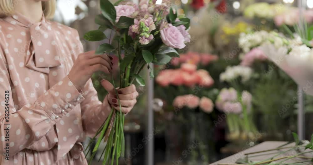 Florist woman make a bouquet of beautiful flowers. Small business owner and beautiful florist woman Florist woman make a bouquet of beautiful flowers. Small business owner and beautiful florist woman