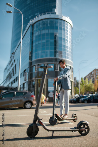 Find your next place to go. Rental electric scooter standing on the street