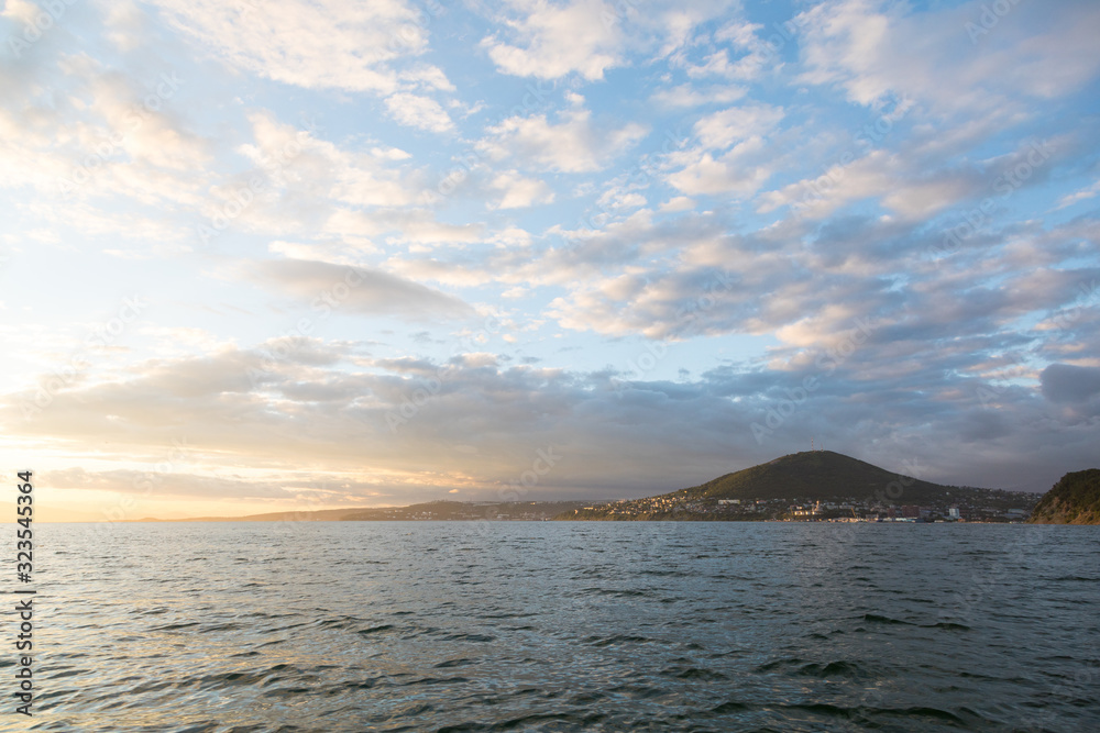 Golden sunset in the sky over the Avacha Bay, Kamchatka Peninsula, Russia.