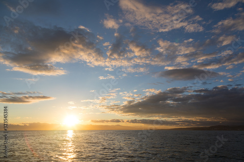 Golden sunset in the sky over the Avacha Bay, Kamchatka Peninsula, Russia.