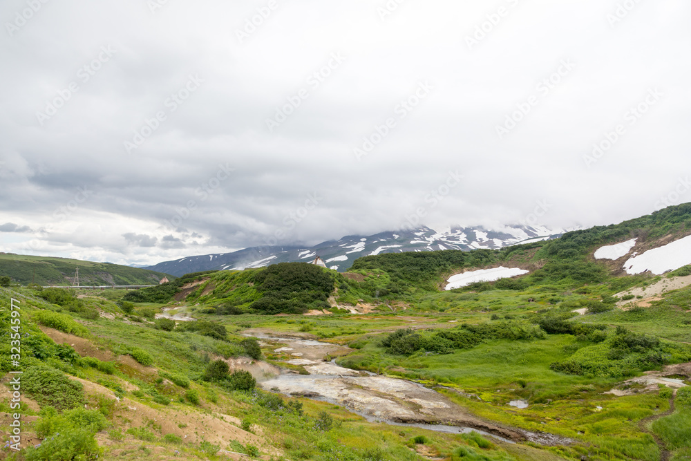 Small Valley of Geysers, Kamchatka Peninsula, Russia. This is a unique active fumarole field, the hot gases of which pass through the water of a cold stream, heating it and creating a gushing effect.