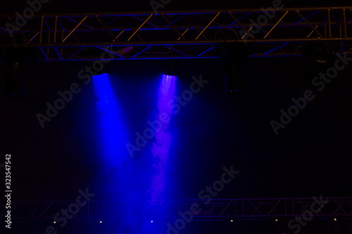 Blue color stage light in dark, with smoke effect