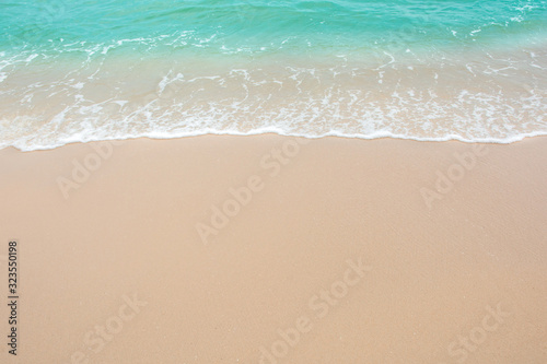 Fototapeta Naklejka Na Ścianę i Meble -  Summer beach concept - Soft wave of sea on empty sandy beach Background with copy space.