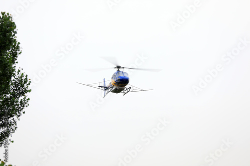 Agricultural helicopters fly in the sky