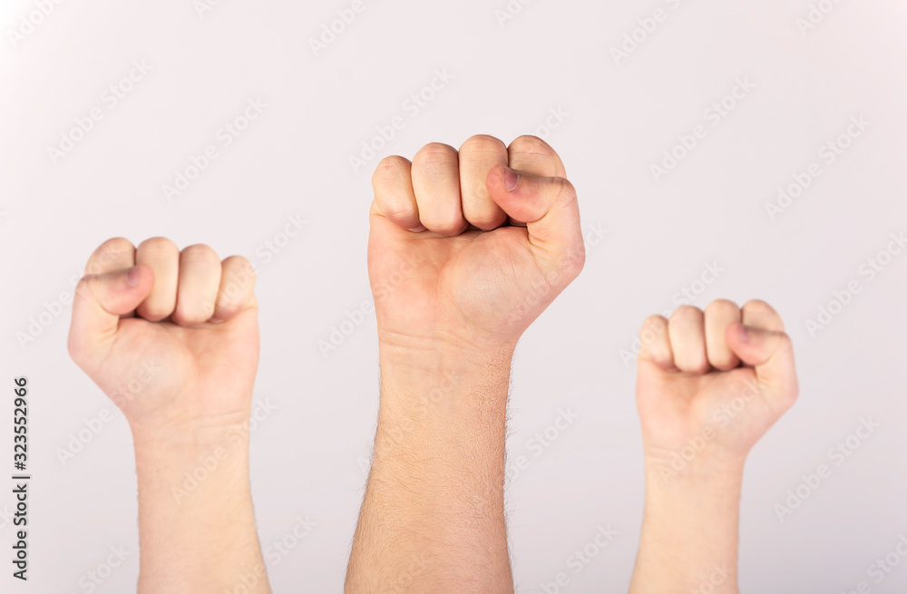 People raised fist air fighting for their rights, labor movement, election movement, copy space. People raised fist air fighting for their rights, labor movement, election movement, copy space.