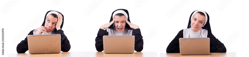 Nun working on laptop - religious concept Nun working on laptop - religious concept