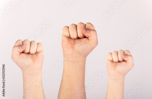 People raised fist air fighting for their rights, labor movement, election movement, copy space.