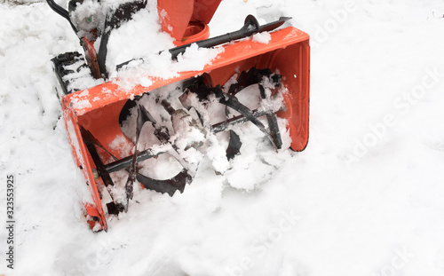 closeup of the first stage impeller of an orange snow blower