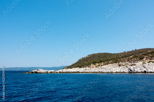 Rocky coast and gorgeous waters in Kelyfos islet, Marmaras, Chalkidiki, Greece © kokixx