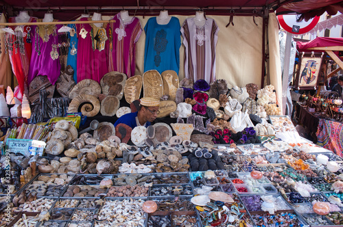 miranda de ebro, España ; may 4, 2019: shopkeeper in his camouflaged stand among his belongings