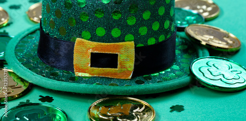 St Patricks Day with close up of hat and gold coins on green background
