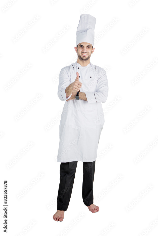 Male chef showing thumb up in studio