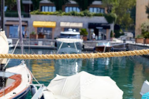 Stretched rope against the backdrop of yachts in a yacht club