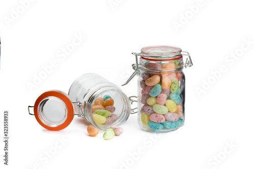 two glass jars with air tight sealing glass lids filled with jelly bean candy isolated on white photo