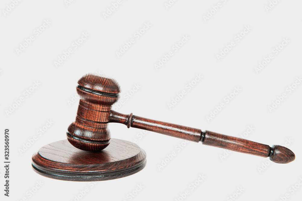 Wooden Judge's gavel on a white isolated background. The concept of justice and dealing with court cases. Citizens' problems in courts, honesty. The work of courts and lawyers. Wooden Judge's gavel on a white isolated background. The concept of justice and dealing with court cases. Citizens' problems in courts, honesty. The work of courts and lawyers.
