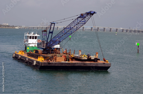 Barge carrying a construction crane on Biscayne Bay off of downtown Miami and the Venetia Causeway.