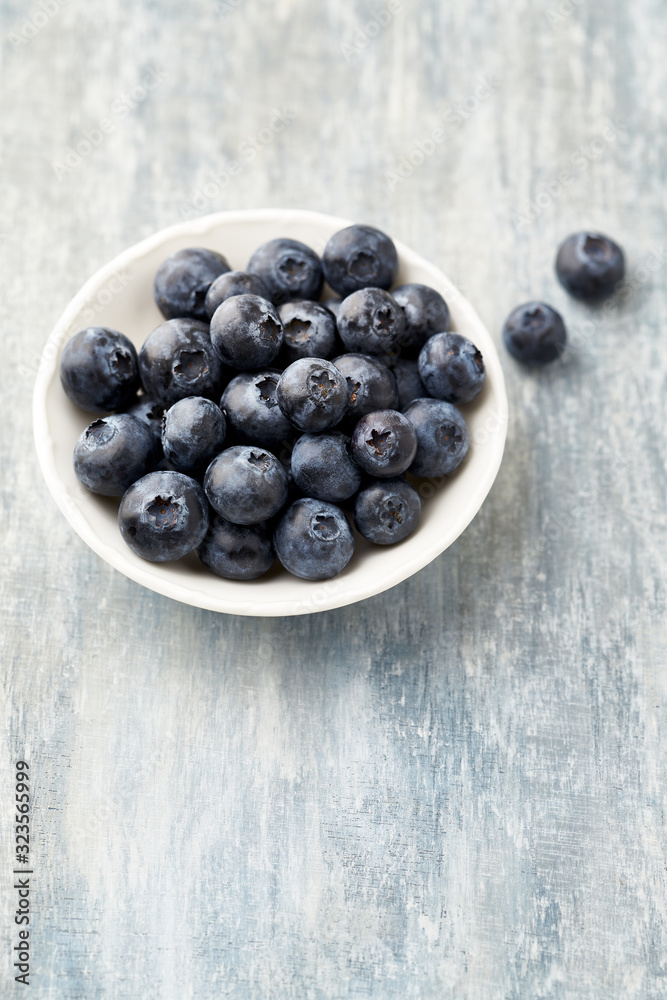 Bilberries on bright wooden background. Concept for healthy nutrition. Copy space. Bilberries on bright wooden background. Concept for healthy nutrition. Copy space.