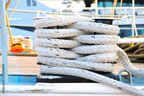 Deck detail of a classic sailing ship, cleat with belayed docking line.